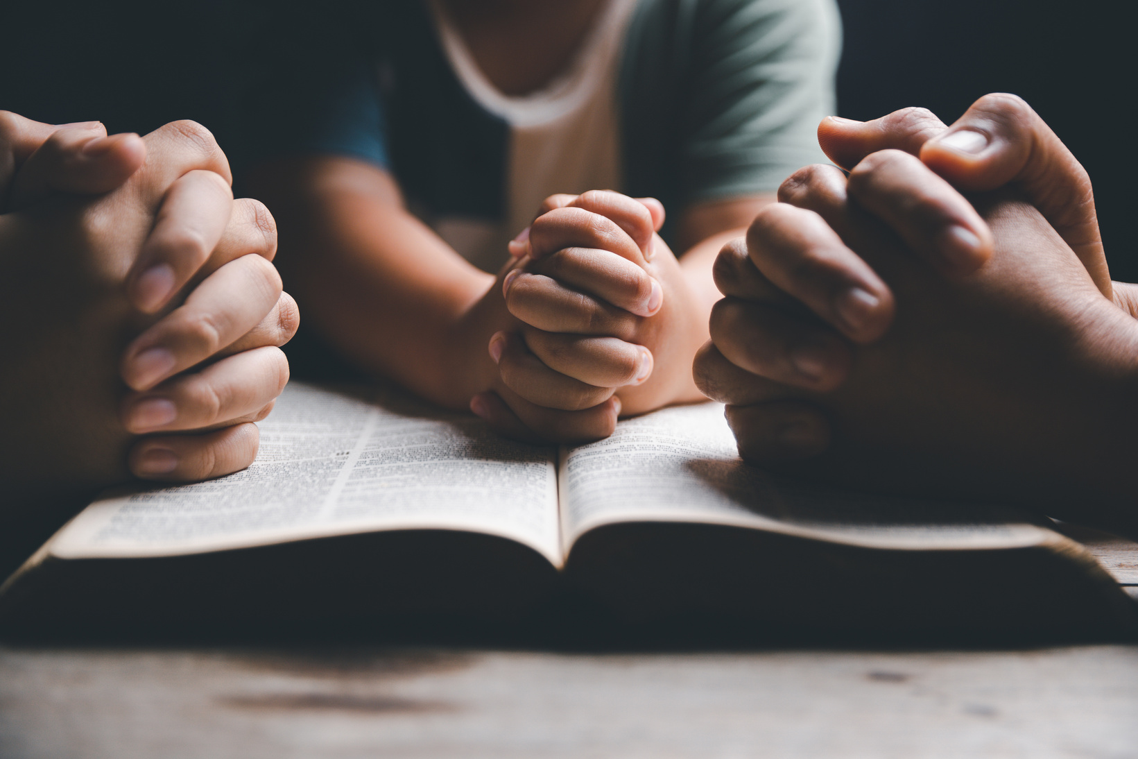 praying at home. Asian christian  with little boy and teen girl praying together.
